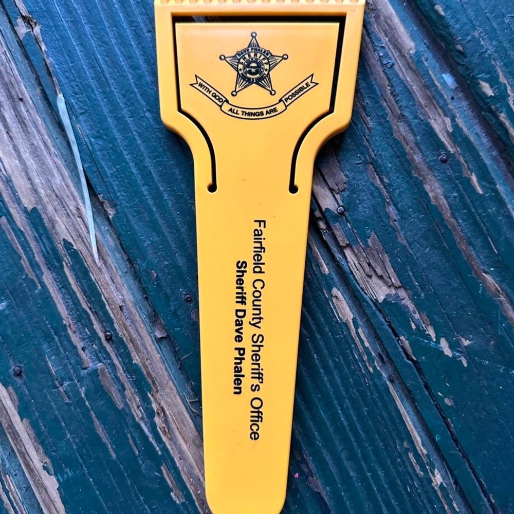 Yellow and black Farfield County Sheriff's Office sheriff's badge snow scrape